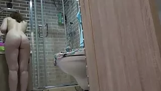 My nude girlfriend freshening up in the bathroom