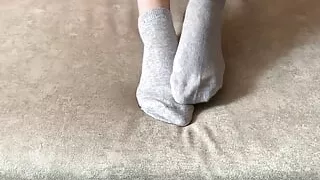 Gloria Gimson strokes her sexy feet in gray socks