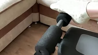 Fitness girl in green socks doing leg exercises on a sports bench