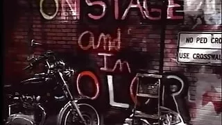 Biker chick fucks man in skull cap outside on the ground