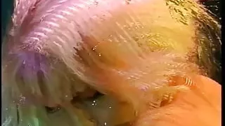 Slutty hot blonde woman sucks long haired male's cock on the couch