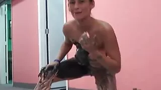 Beautiful slut paint her body with black paint on the floor