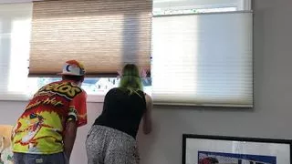 Couple Peeping Outside Apartment Window