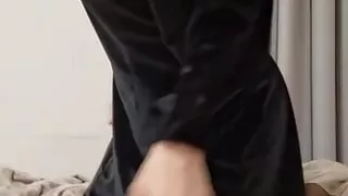 The cutie is lying on the bed pulling up her dress