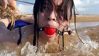 Ball Gagged Latina Hogtied In The Sea