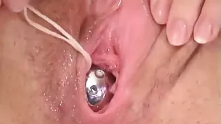 Naughty brunette spreads her pussy wide and slips a huge dildo inside it