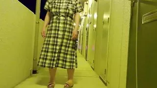A perverted married woman masturbates in the hallway of an apartment