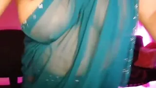 Bhabhi, crazy with the juice of hot youth, is enjoying by opening her bra and showing her boobs through the saree.