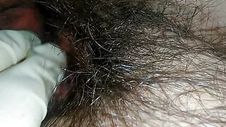 Hairy milf pampers her pussy with latex gloves