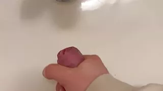 Big cumshot in bathroom by big cock twink