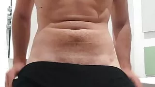 a young man shows his big hard cock before shower