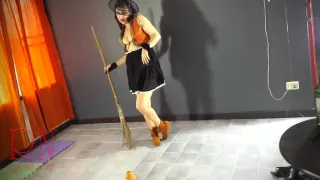 Regina Noir - Halloween Witch In A Sexy Red Suit. Red-haired Witch With Pumpkins And A Broom. Regina