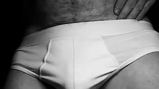 in briefs plays with his bulge