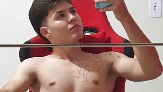 Young boy showing off and masturbating in the mirror