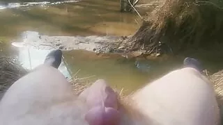 Solo down by the river next to the road