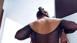 Undressing,  black bodysuit and mini skirt