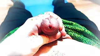 a young guy in green swimming trunks plays with his dick