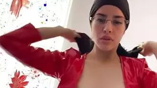 sexy Arab in leather dress doing sensual dance with her hijab on