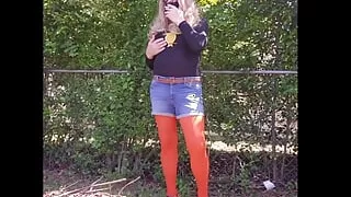 Crossdresser outdoors tease, smoking in nylon pantyhose.
