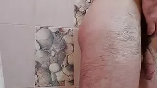 Handsome muscular hairy guy takes a shower.