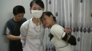 Two Chinese Girls Tied, One Wearing Cloth Mask