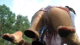 Schoolgirl rides two dildos on the hood of the car