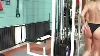 Busty blonde lesbian spices up the workout with the brunette by using a thick strapon