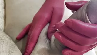 Horny milf jerks a thick dick with gloves on