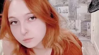 Red-haired juicy babe in a sexy dress