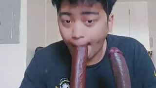 Latino Femboy sucks 2 big black dildos