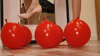 Heels crush balloons. Crushing heels