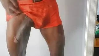 Tall sexy African man with a very big black cock rubs his cock in  front of a mirror home alone