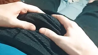 A guy in sweatpants is basking and caressing himself