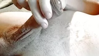 A guy in a red T-shirt cums in close-up on his body, shows sperm