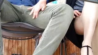 Under the table. The cheating wife invites the neighbor for a drink and  rides him