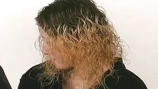 A slim blonde girl slave enjoys getting warm wax all over the body