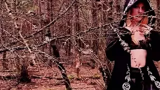 Naughty witch is playing with a vibrator in the forest