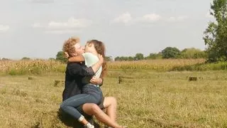 Beautiful Teen Couple in Love Passionately Kissing on the field