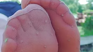 Cute feet in nylon knee socks and white socks teasing you closeup outdoor