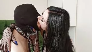 Passionate sexy French kisses. Dominatrix Nika seduces and kisses her masked submissive on the lips.