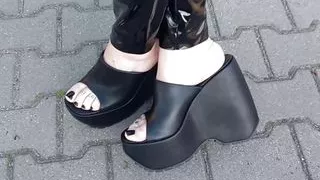 a walk in very high wedges and latex leggings