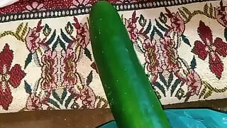 Aunty drains the water from the cucumber while relishing the cucumber to the fullest.