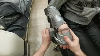 Silver tape tied to chair, leather pants, sock gagged