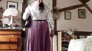 In bourgeoise attire with an old pink pleated skirt for a day