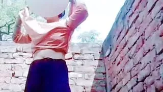 A very beautiful girl was taking bath in her courtyard