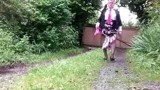 In a little floral skirt and fuchsia tie with stains in the garden for an evening