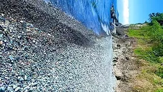 Guy jerking off dick on a nudist beach and a passerby joined him