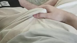 A guy in white shorts gently strokes his penis