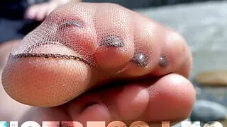 Goddess In Tan Nylons Show Her Cute Nylon Soles And Toes On The Riverside