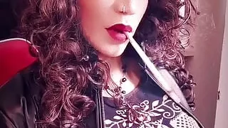 Leather trans girl with big cock smoking a long cigarette